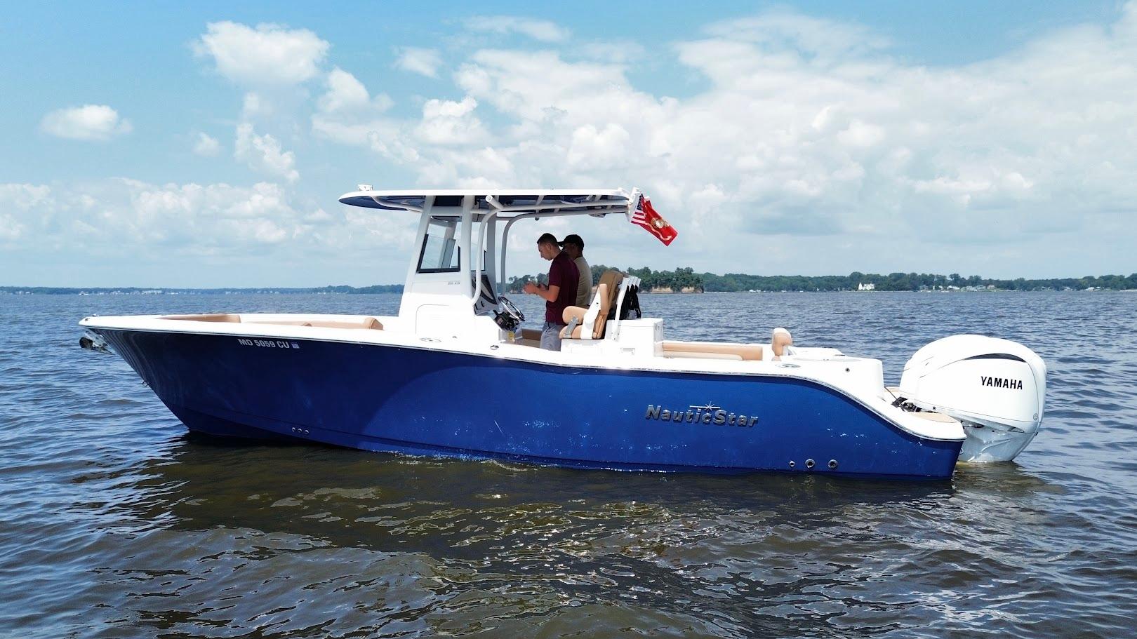 NauticStar 28 XS 2023 NauticStar 28 XS boat on water with Yamaha engine, clear sky background.