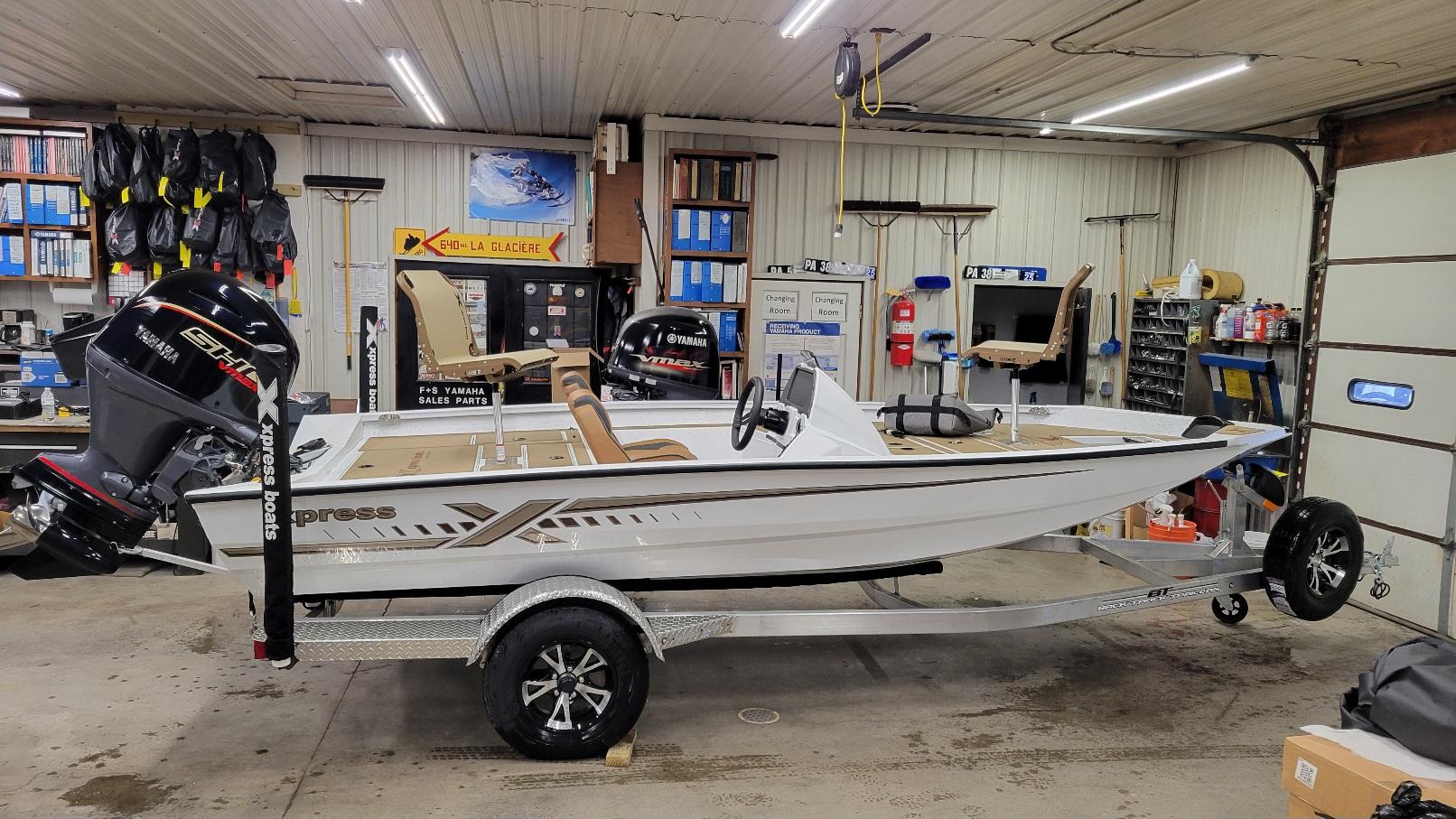 Xpress H18C Crappie w/ Yamaha Vmax 115 (In stock!) 2025 Xpress H18C Crappie boat with Yamaha Vmax 115 in a garage setting.