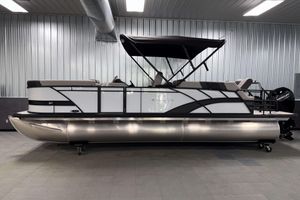 Sylvan L3 LZ 2026 Sylvan L3 LZ pontoon boat in a showroom with sleek design and canopy.