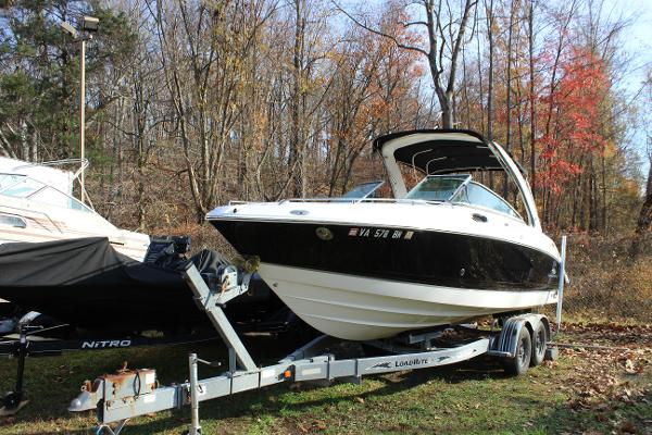 Chaparral 256 SSi 2006 Chaparral 256 SSi boat on trailer in wooded area.