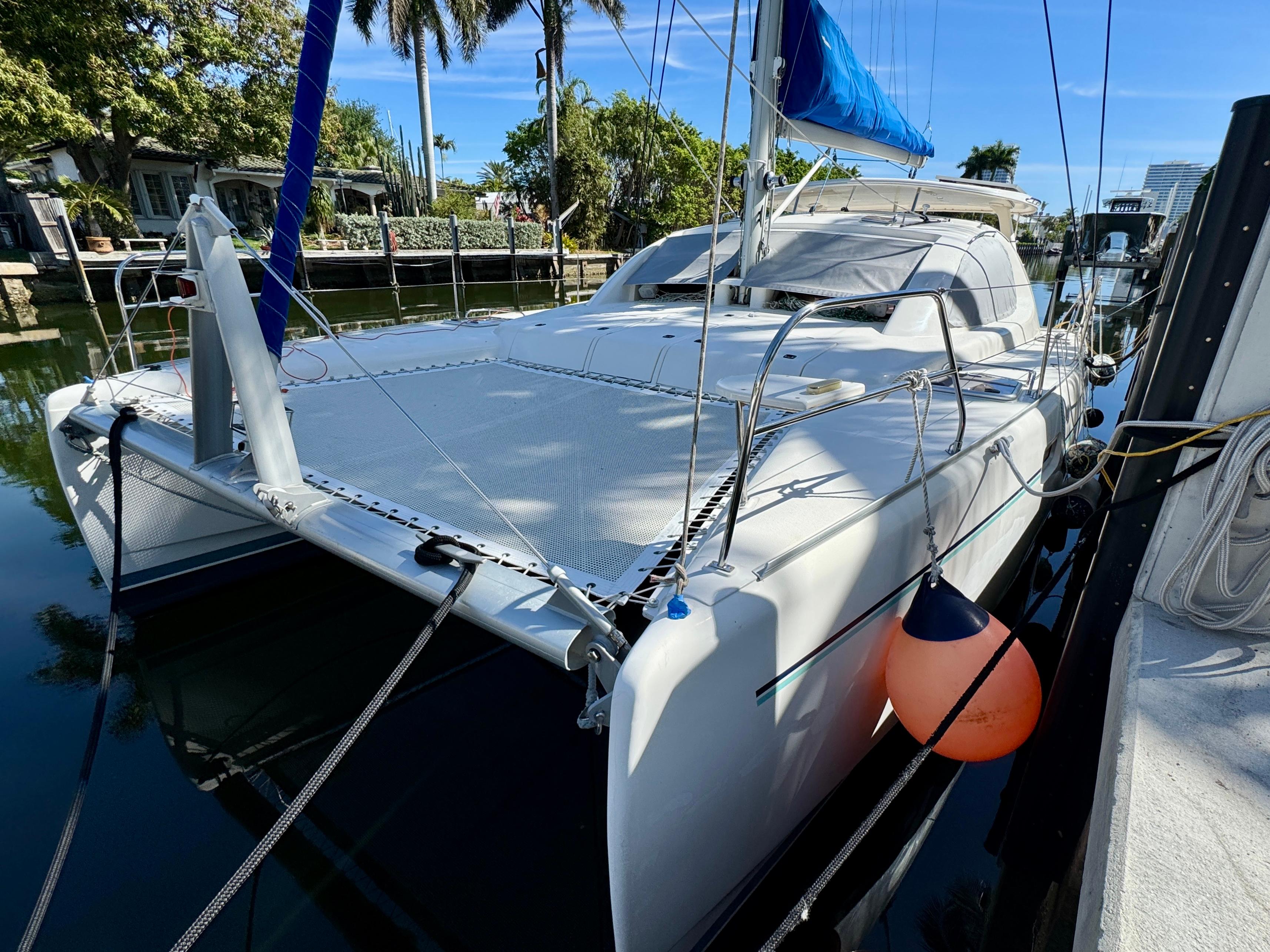 Leopard 40 2006 Leopard 40 catamaran docked, featuring a blue sail and spacious deck.