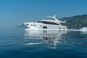 Princess 82 Luxury 2016 Princess 82 yacht cruising on calm blue waters near scenic coastline.
