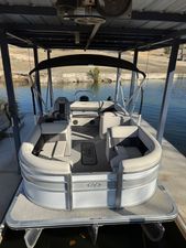 Harris Cruiser 210 2022 Harris Cruiser 210 pontoon boat docked under a covered structure.