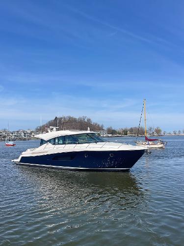 Tiara Yachts 53 Coupe 2020 Tiara Yachts 53 Coupe on calm water under clear blue sky.