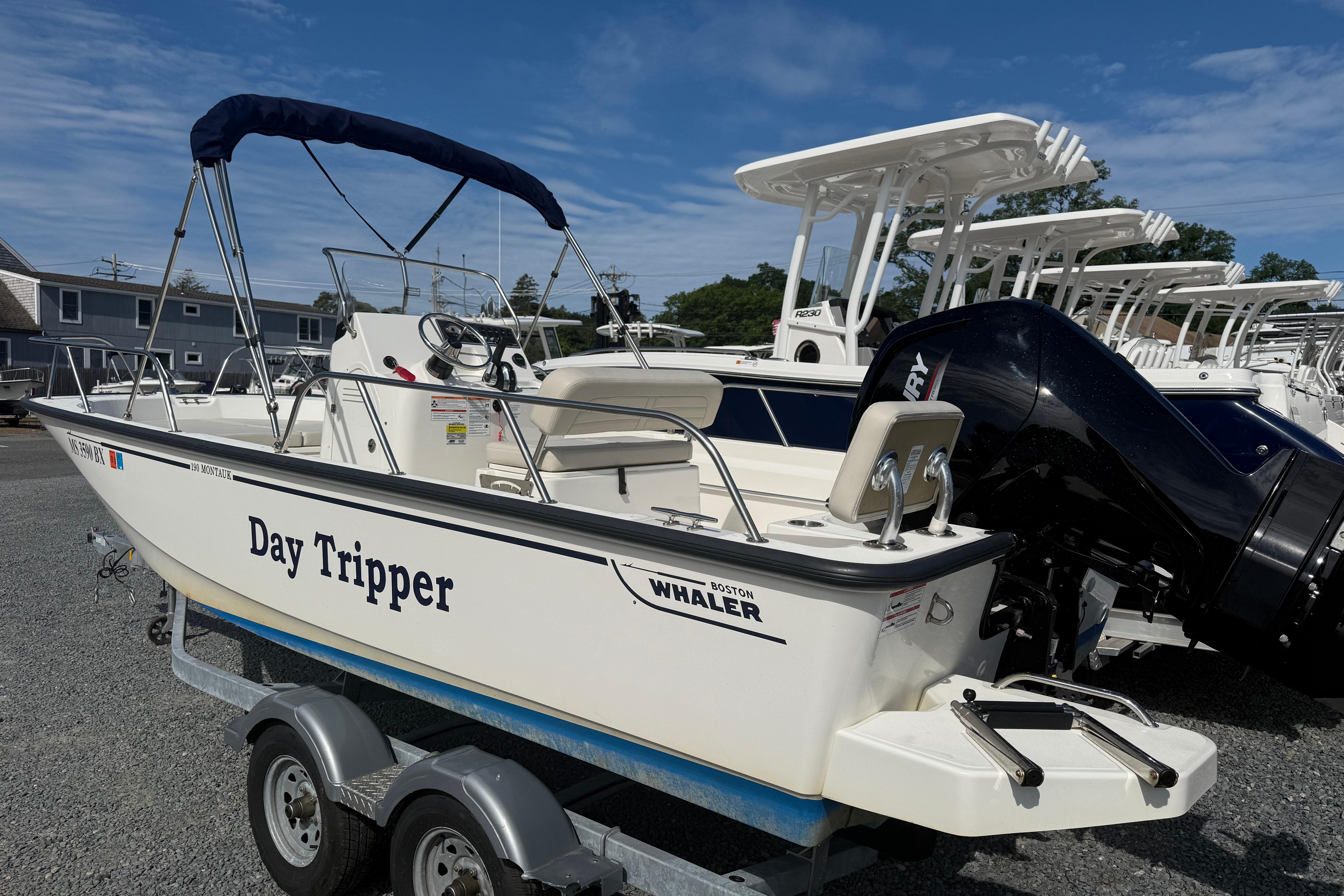 Boston Whaler 190 Montauk 2024 Boston Whaler 190 Montauk boat named "Day Tripper" on a trailer, sunny day.