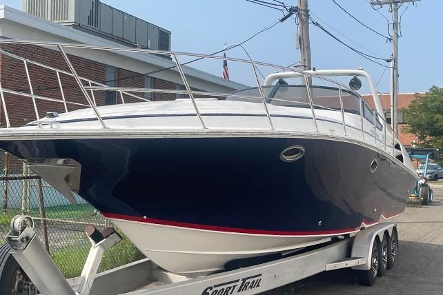 Fountain 38 Express Cruiser 2002 Fountain 38 Express Cruiser on trailer, parked outdoors.