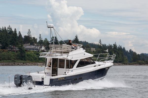 Cutwater 32 CB 2024 Cutwater 32 CB cruising on a scenic lake with forested shoreline.