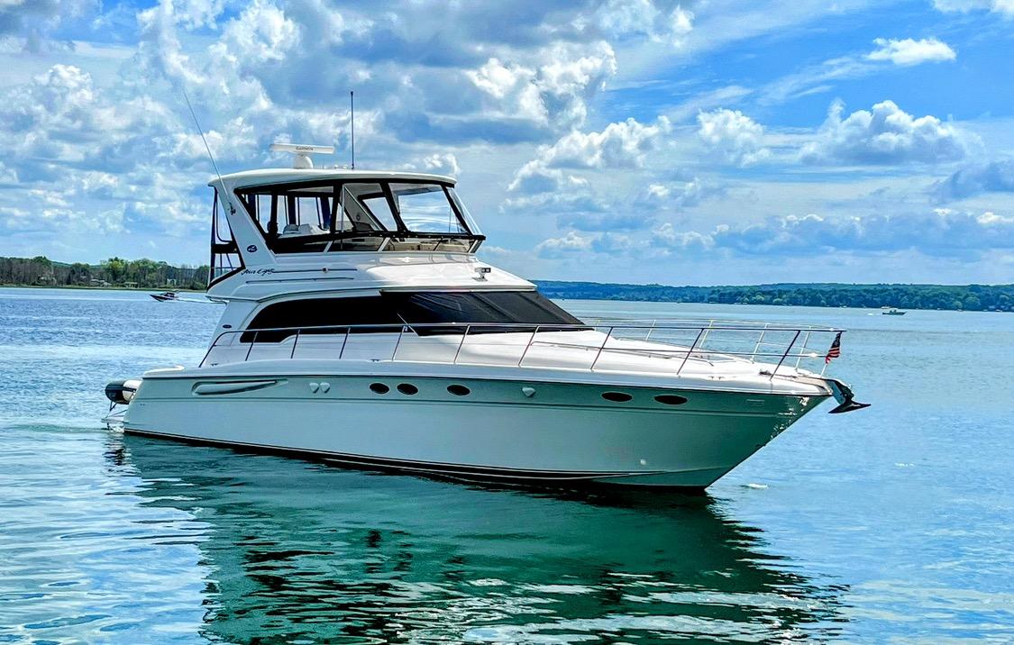 Sea Ray 480 Sedan Bridge 1998 Sea Ray 480 Sedan Bridge yacht on calm water under a partly cloudy sky.