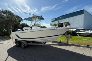 Cobia 224 Center Console 1999 Cobia 224 Center Console boat on trailer, parked near a marine facility.