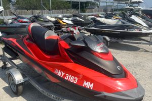Sea-Doo RXT-X 300 2016 Sea-Doo RXT-X 300 jet ski in vibrant red, parked on a trailer.