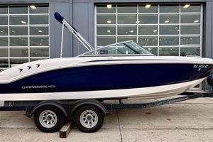 Chaparral 210 Suncoast Ski & Fish 2016 Chaparral 210 Suncoast Ski & Fish boat on trailer, parked outside a building.