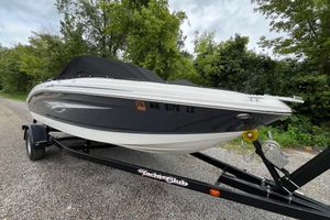 Chaparral 19 H2O Ski & Fish 2014 Chaparral 18 H2O Ski & Fish boat on trailer, parked on gravel road.