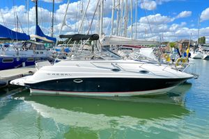 Regal Commodore 2665 2004 Regal Commodore 2665 boat docked in a marina under a blue sky.