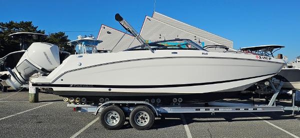 Four Winns HD5 OB 2024 Four Winns HD5 OB boat on trailer in parking lot.