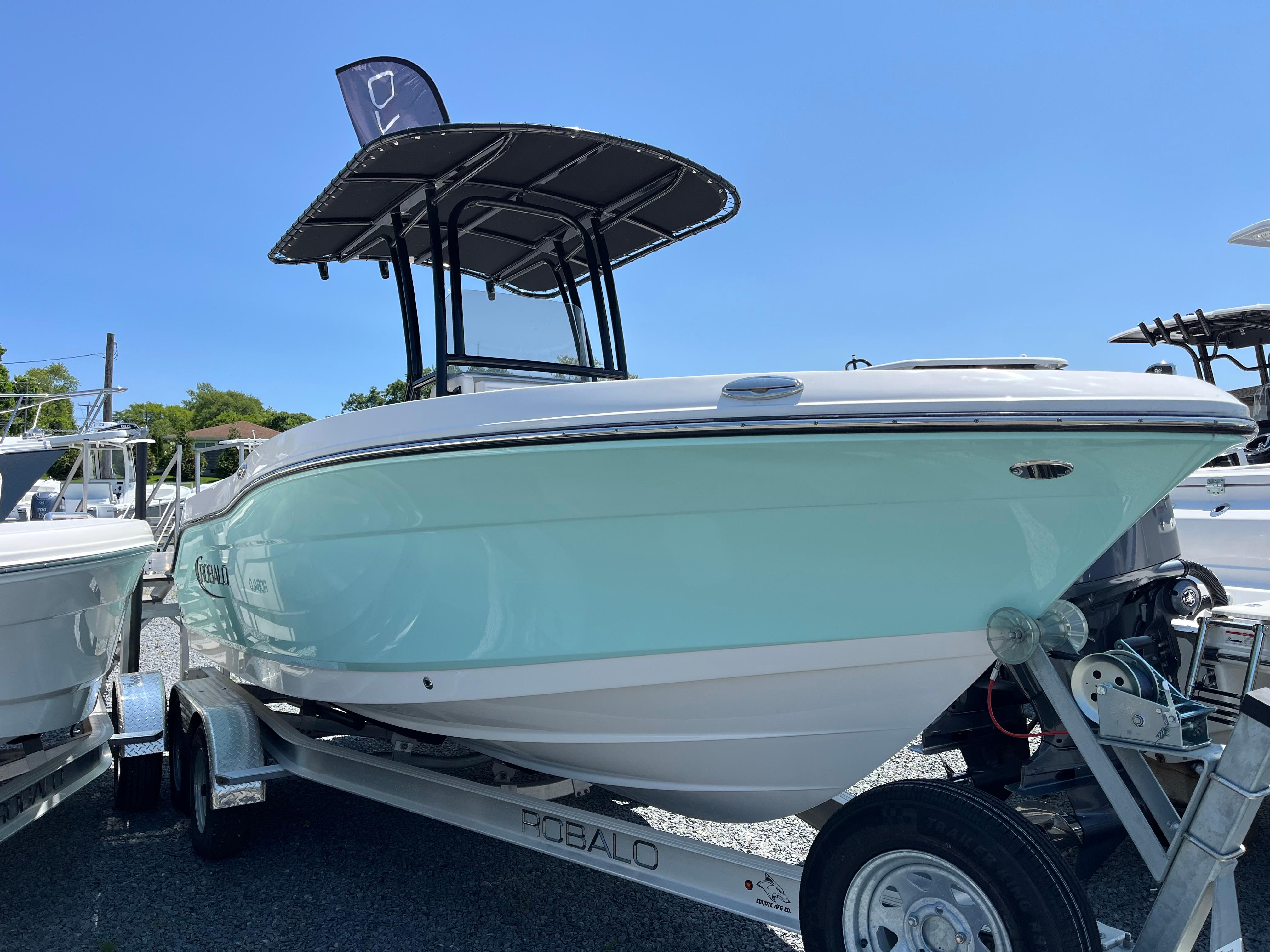 Robalo R200 Center Console 2024 Robalo R200 Center Console boat on trailer under clear blue sky.