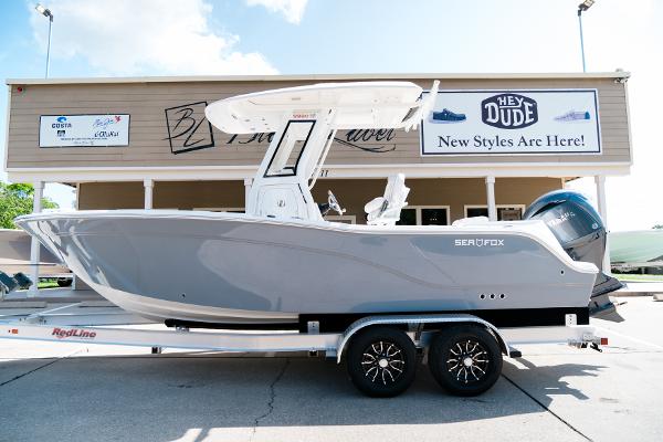 Sea Fox 228 Commander 2025 Sea Fox 228 Commander boat on trailer, parked outside a store with signage.