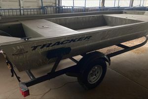 Tracker Grizzly 1754 Jon 2025 Tracker Grizzly 1754 Jon boat on trailer in garage setting.