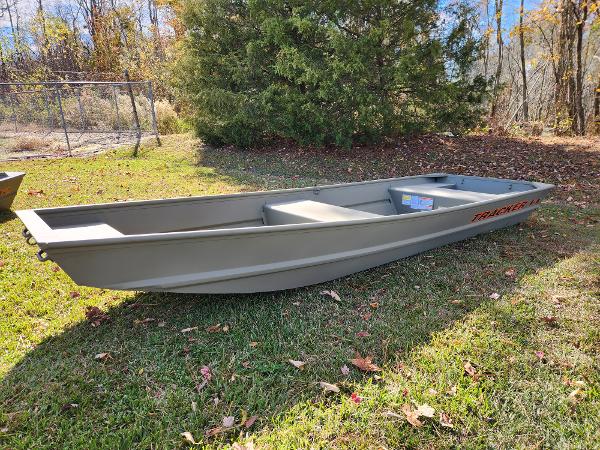 Tracker Grizzly 1436 Utility 2025 Tracker Grizzly 1436 Utility boat on grass, surrounded by trees.
