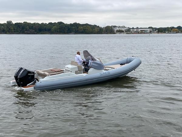 SACS Strider 900 2024 SACS Strider 900 inflatable boat cruising on a calm lake.