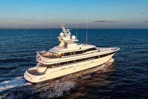 Feadship Custom Luxurious 2001 Feadship Custom yacht cruising on open sea at sunset.