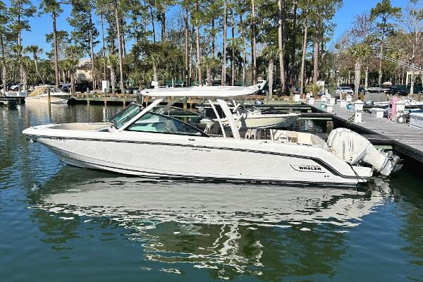 Boston Whaler 320 Vantage 2017 Boston Whaler 320 Vantage boat docked in a serene marina setting.
