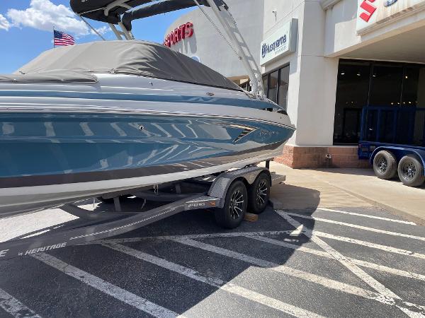 Crownline 240SS 2023 Crownline 240SS boat on a trailer outside a dealership.