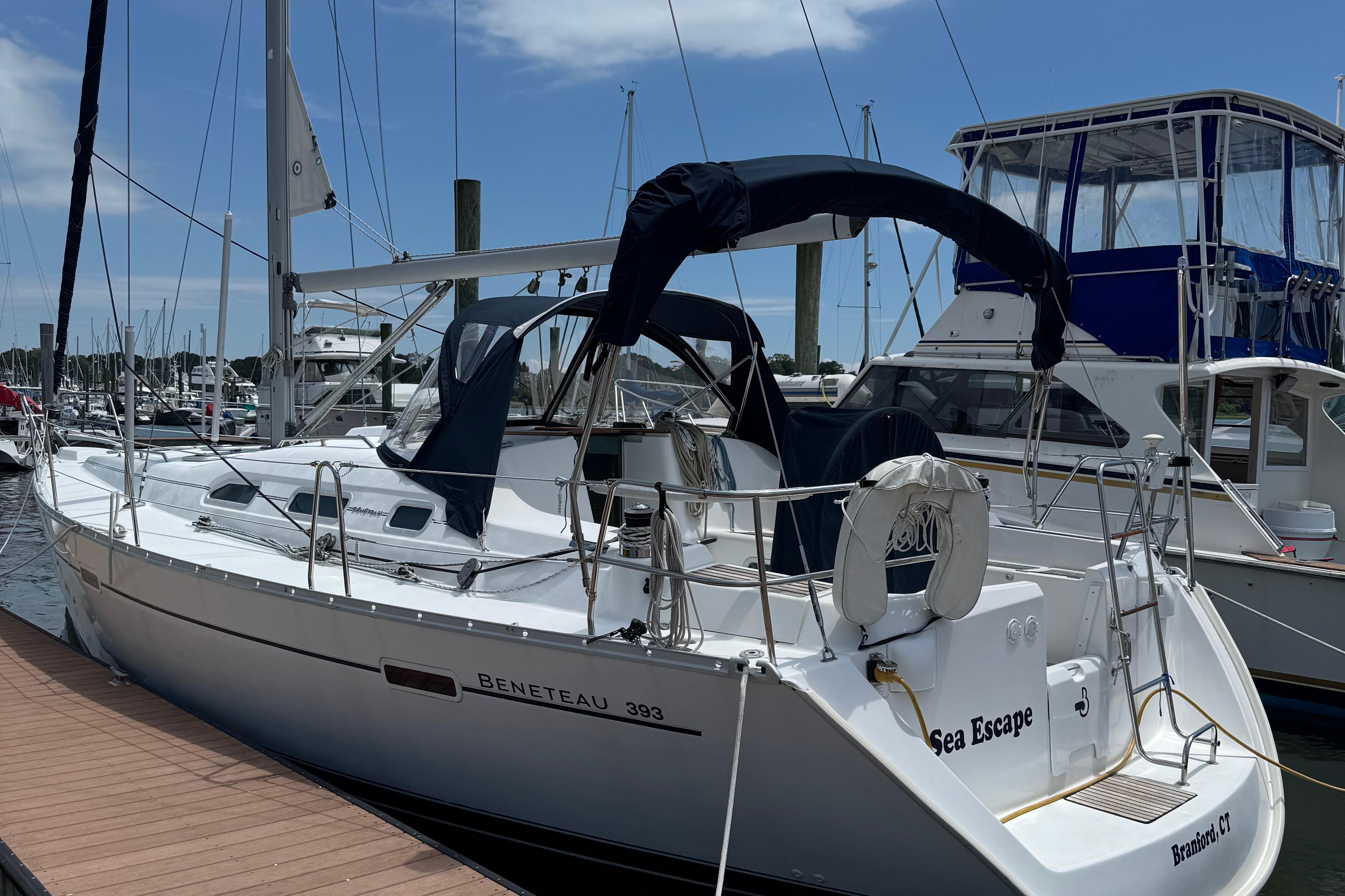 Beneteau 393 2003 Beneteau 393 sailboat docked at marina under clear blue sky.