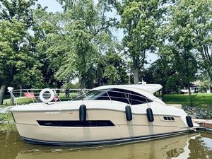 Carver C37 Coupe 2017 Carver C37 Coupe yacht docked by lush green trees.