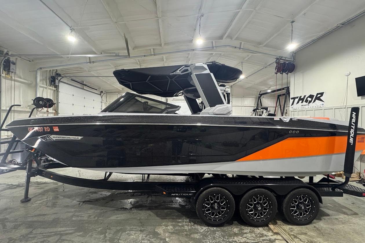 Nautique Super Air Nautique G25 2022 Nautique Super Air Nautique G25 boat in a garage, black and orange design.