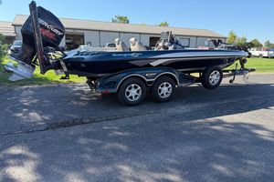 Ranger Z521 2011 Ranger Z521 boat with Mercury engine on trailer, parked outdoors.