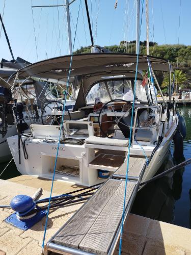 Dufour 360 2018 Dufour 360 sailboat docked at marina, featuring spacious cockpit and modern design.