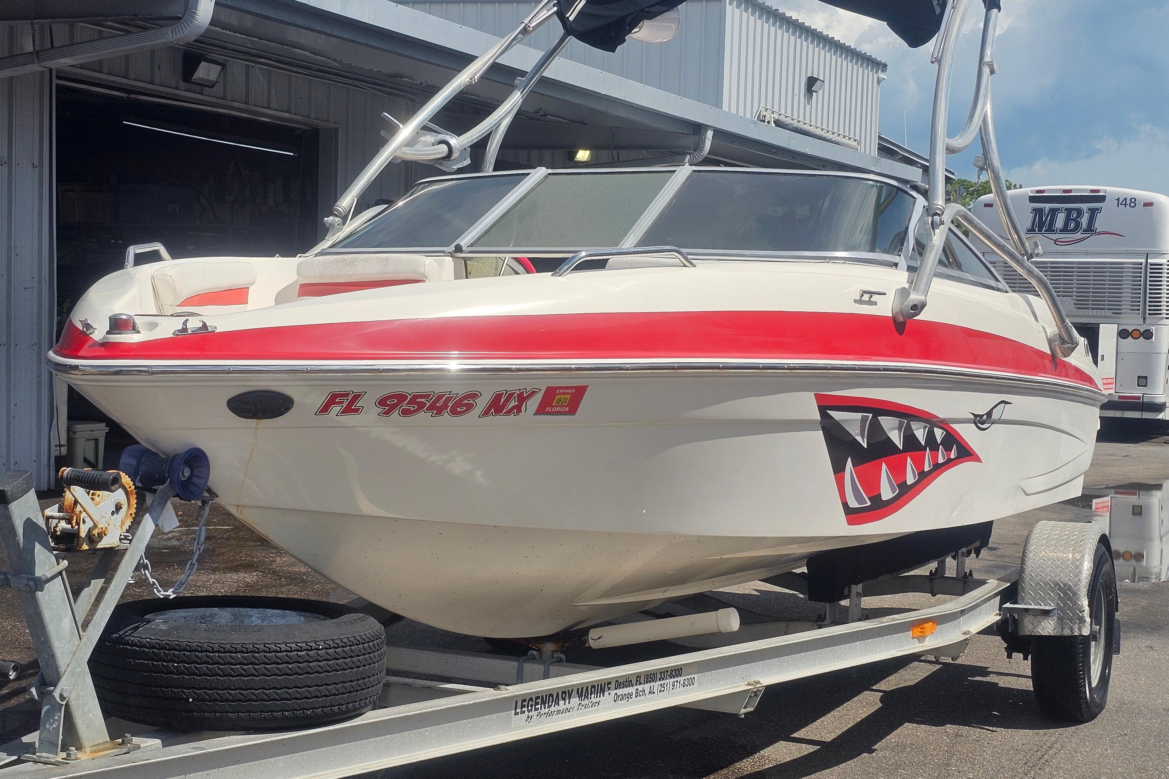 Glastron GT 205 2008 Glastron GT 205 boat with shark mouth decal on trailer.