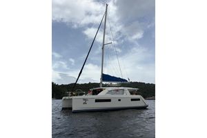 Leopard 404 2016 Leopard 404 catamaran with blue sails on a calm water backdrop.