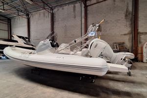 SACS Strider 800 2021 SACS Strider 800 inflatable boat in warehouse, featuring Yamaha outboard motor.