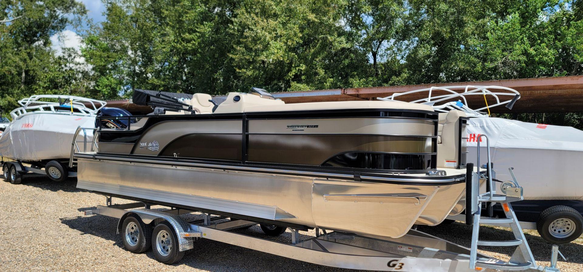 SunCatcher Select 324 SS 2024 SunCatcher Select 324 SS pontoon boat on a trailer, parked outdoors.