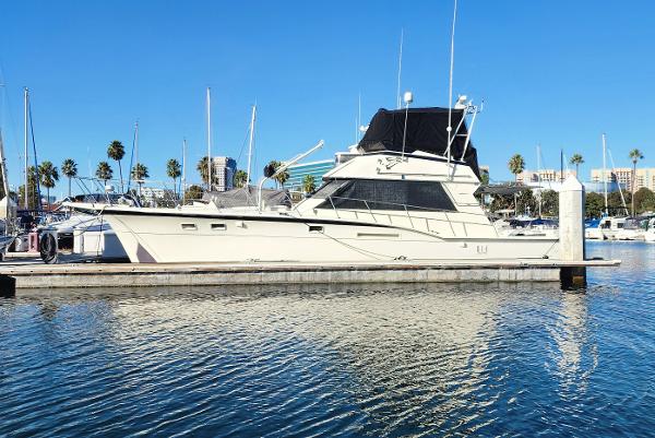 Hatteras Sportfish 1978 Hatteras Sportfish yacht docked in a marina under clear blue skies.