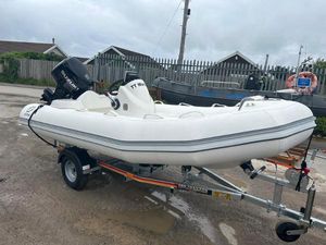 Zodiac Yachtline 400 2023 Zodiac Yachtline 400 inflatable boat on trailer, parked outdoors.