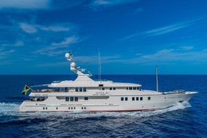 Amels 171 Luxurious 2004 Amels 171 yacht cruising on open sea under clear blue sky.