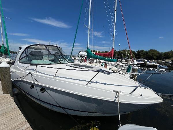 Rinker 320 EX 2017 Rinker 320 EX boat docked at marina under clear blue sky.