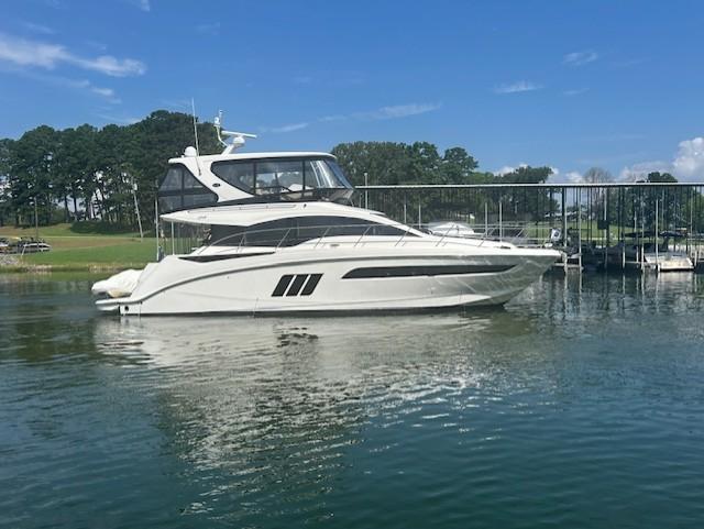 Sea Ray 510 Fly 2016 Sea Ray 510 Fly yacht on calm water, docked near a marina.