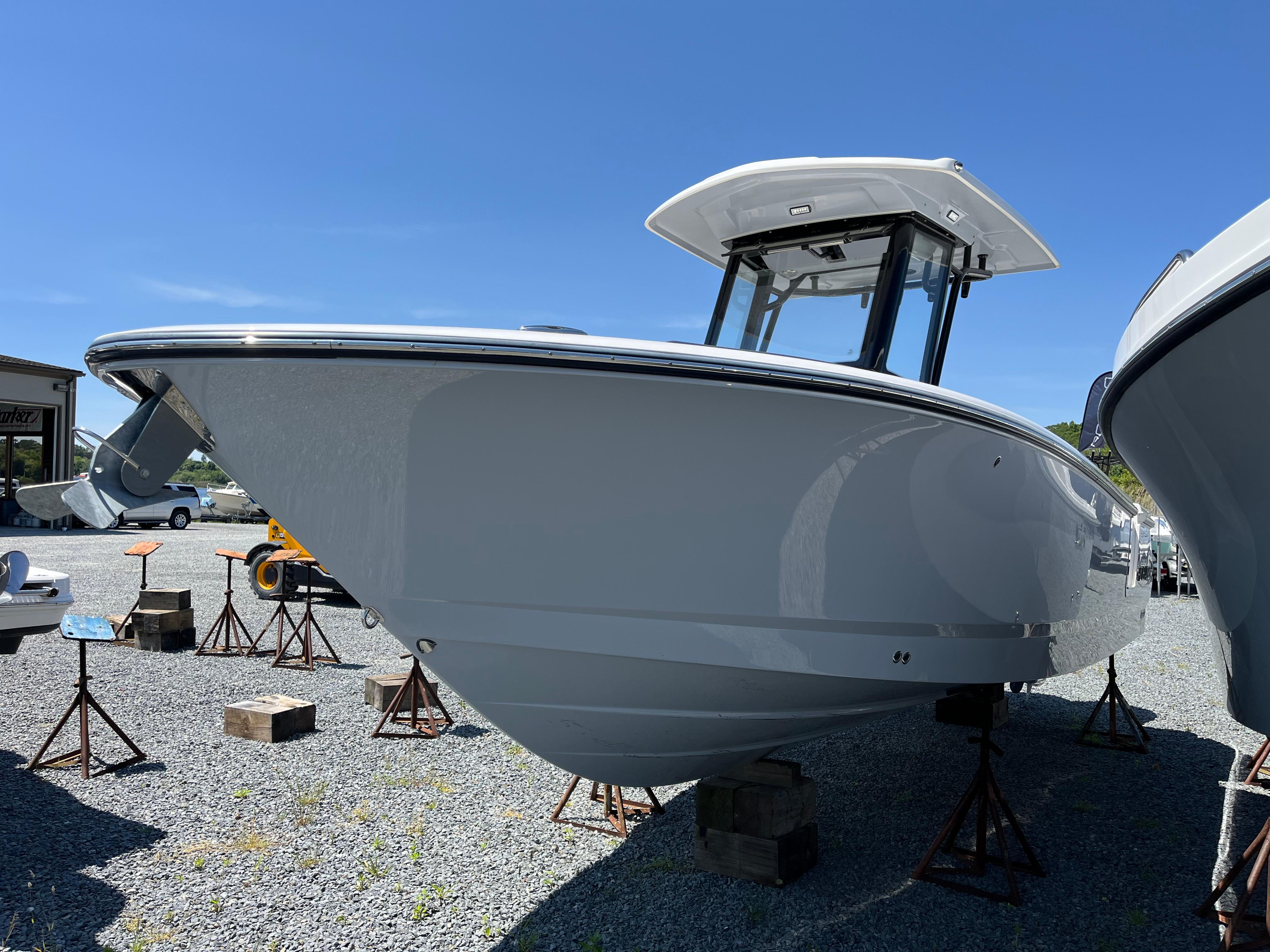 Robalo R250 Center Console 2024 Robalo R250 Center Console boat displayed on stands outdoors.