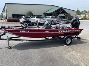 Tracker Pro 170 2022 Tracker PRO170 boat on trailer, red color, parked near industrial building.
