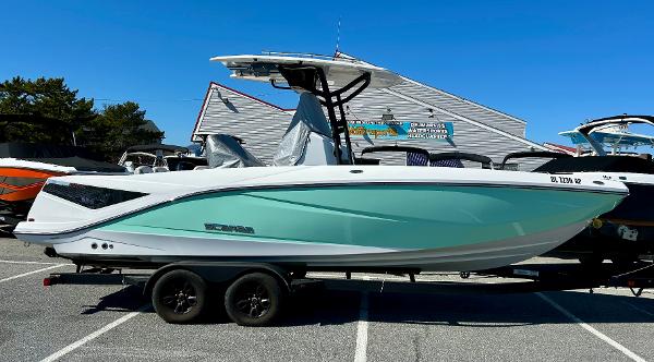 Scarab 255 Open 2024 Scarab 255 Open boat on trailer, displayed outdoors under clear blue sky.