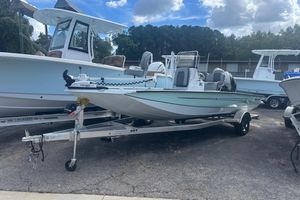 Xpress H20B Bay 2024 Xpress H20B Bay boat on trailer, parked outdoors under a cloudy sky.