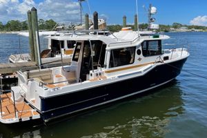 Ranger Tugs R-29 S 2026 Ranger Tugs R-29 S docked, featuring sleek design and spacious deck.