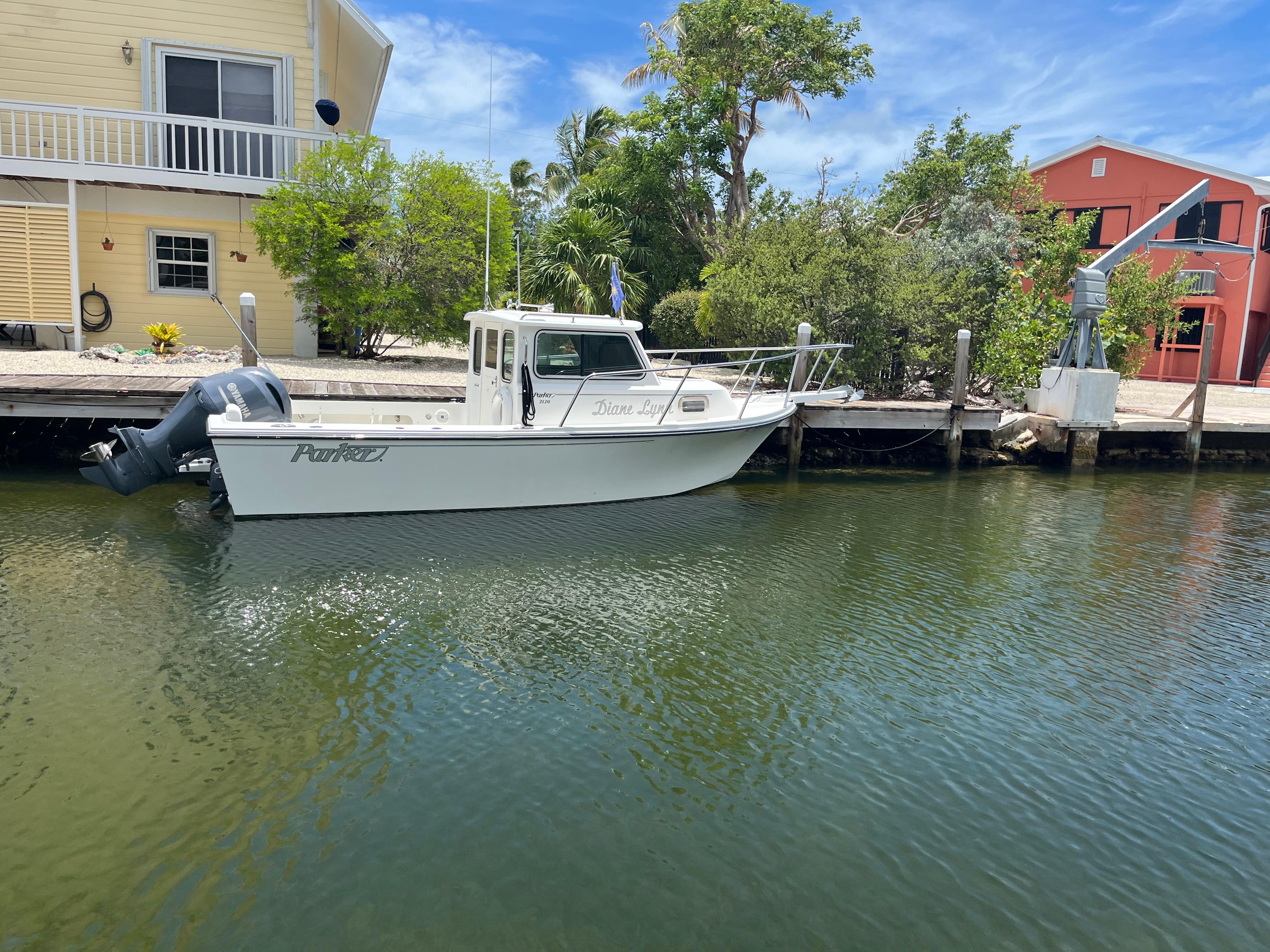 Parker 2120 Sport Cabin 2016 Parker 2120 Sport Cabin boat docked by waterfront homes.