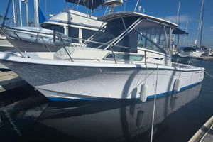 Grady-White Marlin 280 1990 Grady-White Marlin 280 boat docked at marina, clear blue sky background.