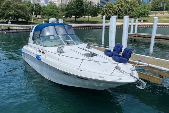 Sea Ray 310 Sundancer 2000 Sea Ray 310 Sundancer docked in a marina, surrounded by calm water and greenery.