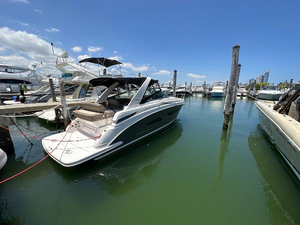Regal 32 Express 2015 Regal 32 Express boat docked in a marina under a clear blue sky.