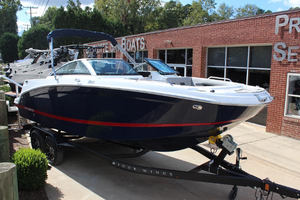 Four Winns HD3 2025 Four Winns HD3 boat on trailer outside dealership.